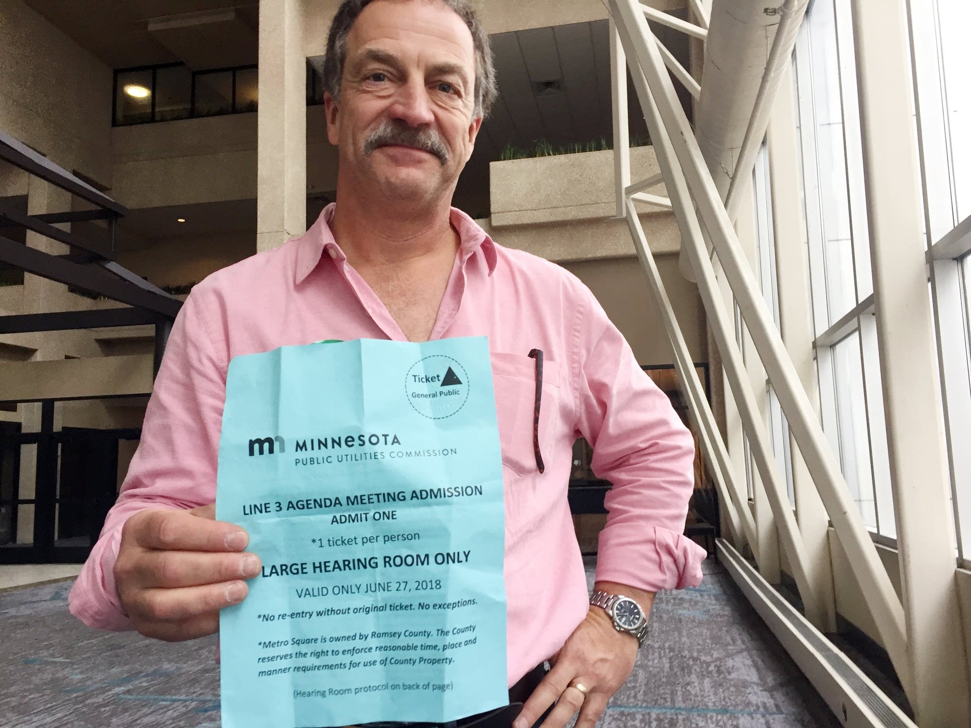 Bob Shoenberger, founder of Minnesotans for Line 3, display a PUC ticket.
