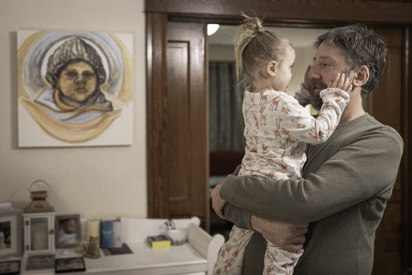 man holds his daughter