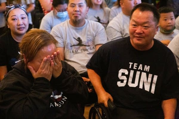 A close-up photo of family members as they react to Sunisa's performance