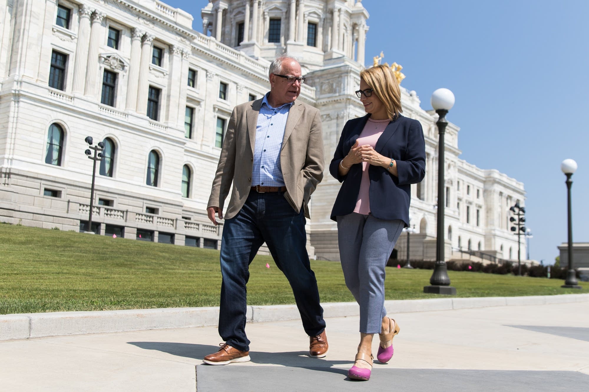 Tim Walz makes his way to the State Office Building with Peggy Flanagan.