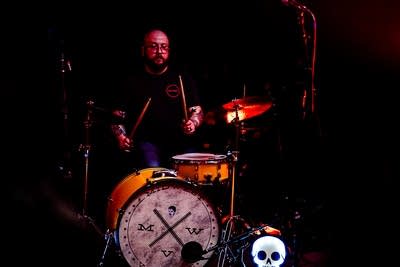 A musician plays drums onstage