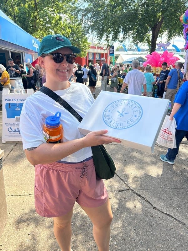 woman holding peachey's baking company box