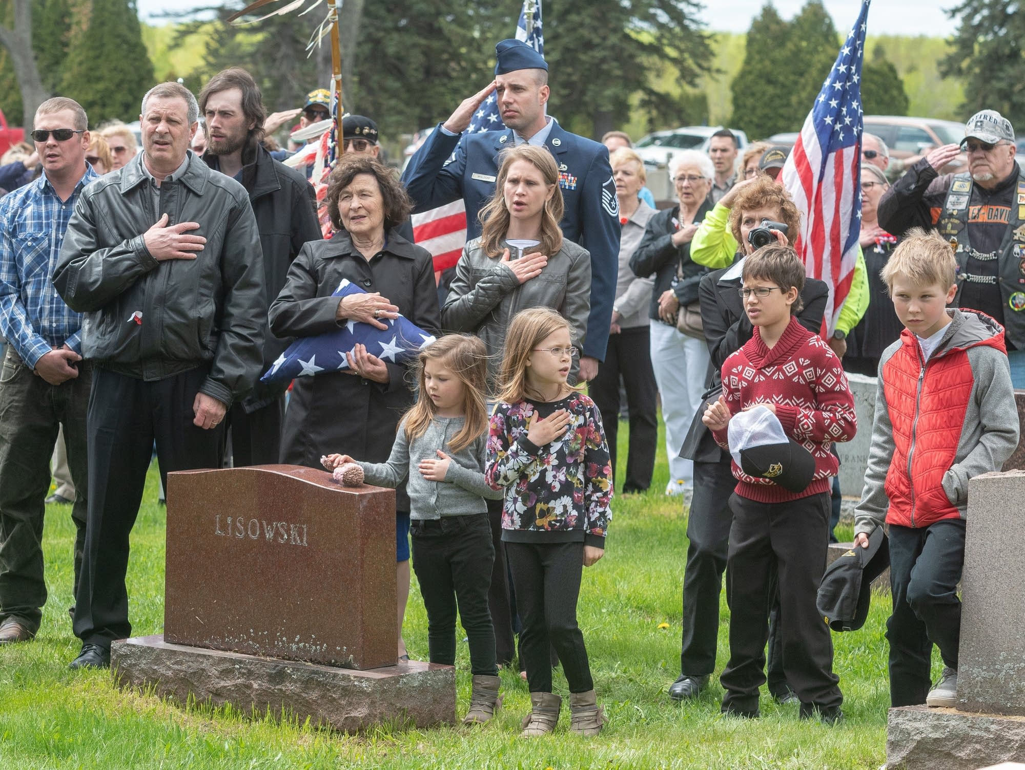 Family and community members attending the burial of Dante Tini