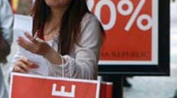 A Banana Republic customer looks at her receipt as she leaves a store in San Francisco