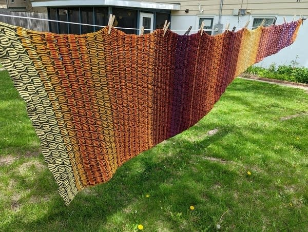 A long blanket spread out on a clothesline