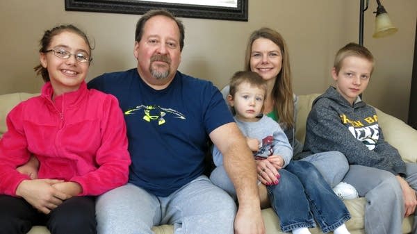 John and Cindy Ness sit with three of their children, Tiena, Zack and Noah.