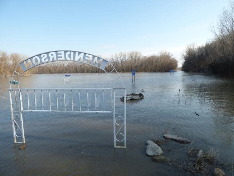 Highway 93 leading into Henderson is completely submerged in water.