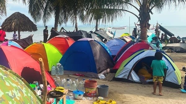 Migrants' tents line a beach in Necoclí, Colombia. It's a key staging post on their journey north to the U.S.