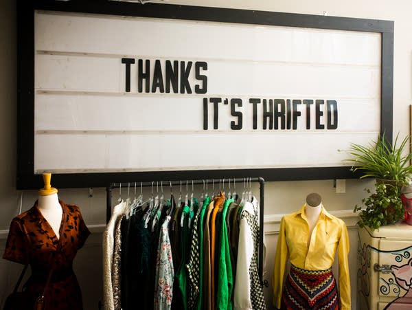 thrift store interior with sign that says thank you it's thrifted