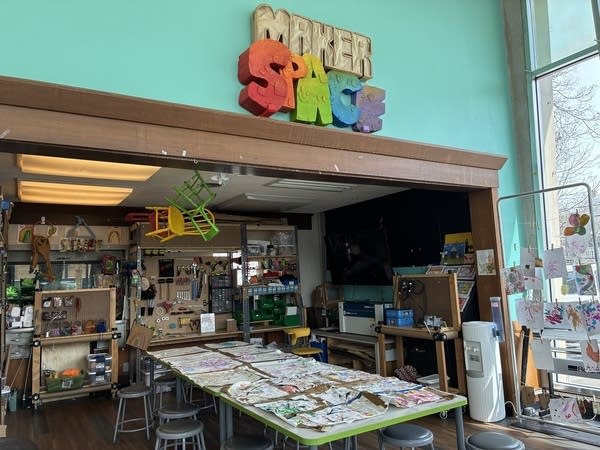 An art station at the children's museum in Beaver County features lots of craft tools, and an array of messy art projects on a work table.