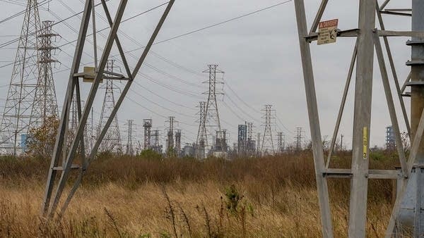 Texas lawmakers are debating a bill that would fund new natural gas plants to act as a sort of fleet of emergency generators. Above, transmission towers near Houston.
