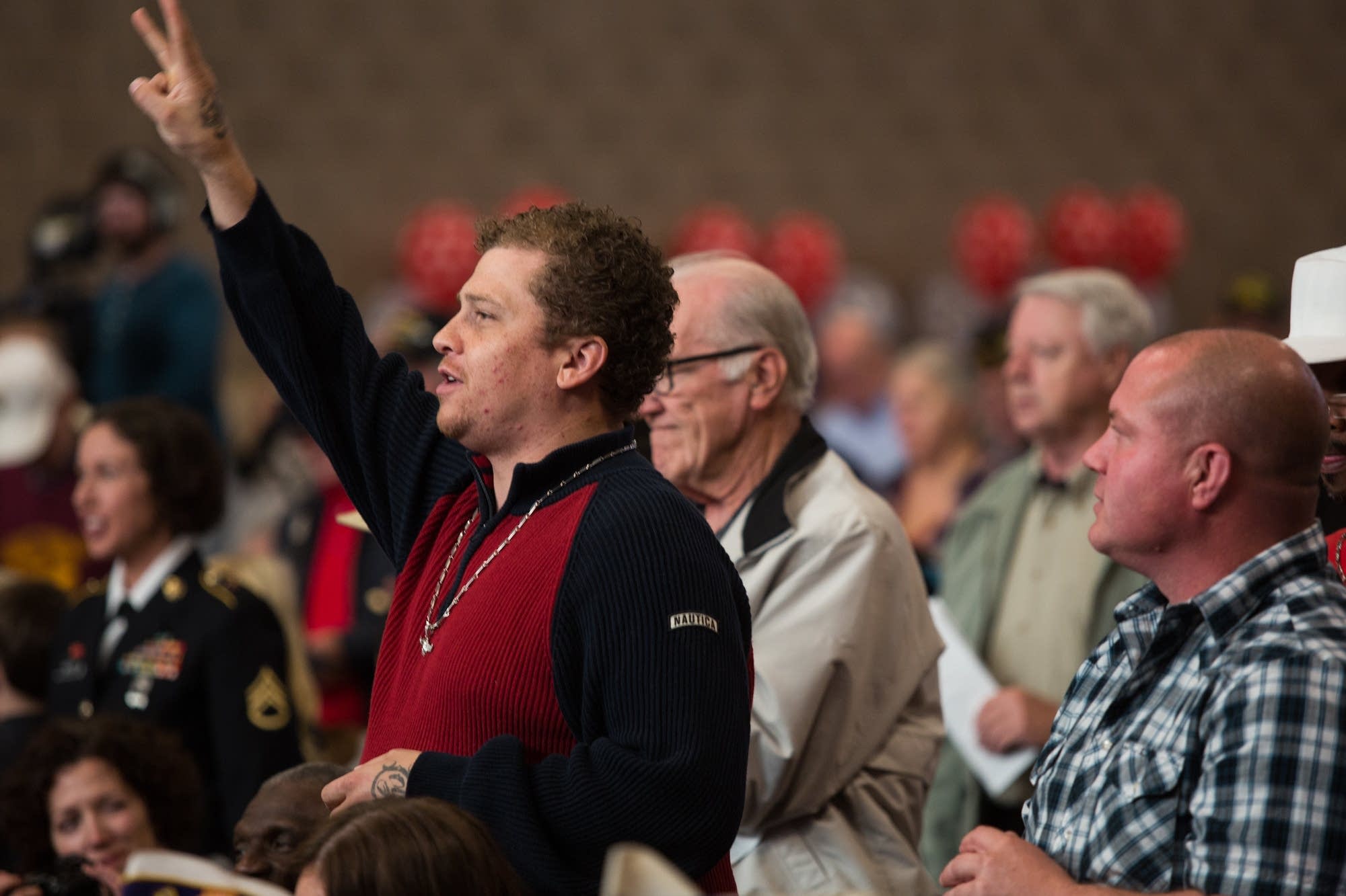 Alex Kempe stands as the Army salute is played.