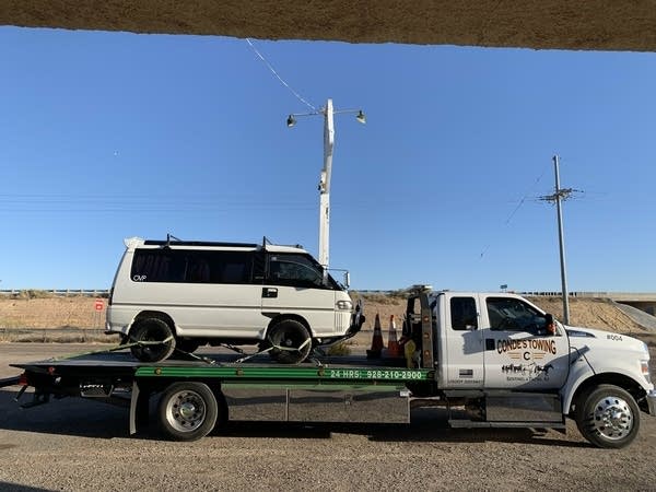 A '93 Mitsubishi Delica van on a flatbed tow truck