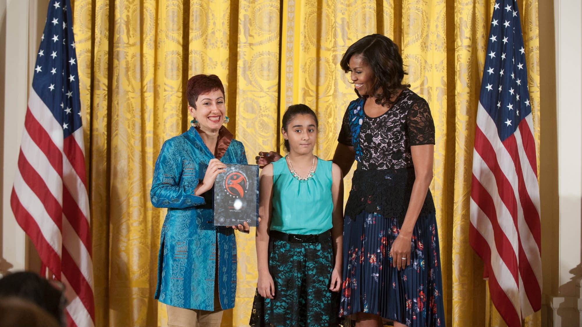 Afa Dworkin accepts the National Arts and Humanities Youth Program Award.