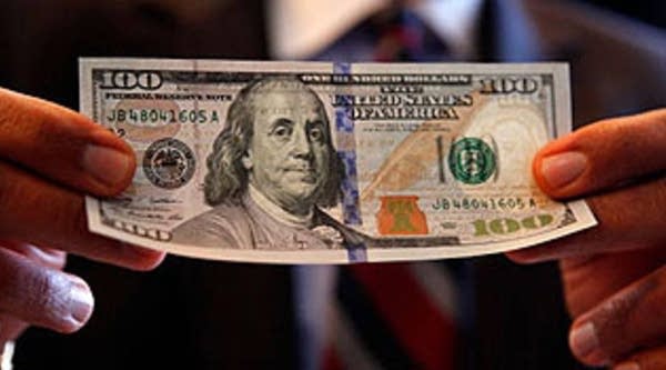 U.S. Bureau of Engraving and Printing Director Larry Felix explains some of the security features of the new $100 note after it was unveiled at the Treasury Department April 21, 2010 in Washington, DC. According to the Treasury Department, the U.S. government evaluates advances in digital and printing technology to redesign currency and stay ahead of counterfeiters. The new note will be put into circulation in Feburary 2011.