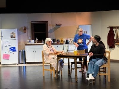 Three actors on a stage.