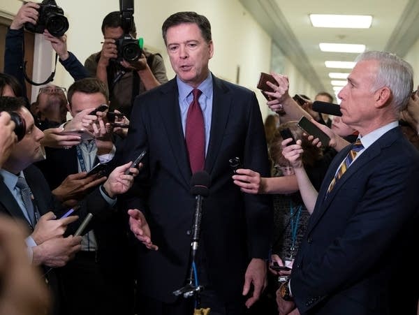 Former FBI Director James Comey talks to reporters