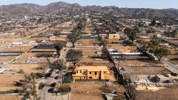 Above, home construction in Pacific Palisades, California, after this year's devastating fires. Climate change will continue to increase the costs of natural disaster recovery. 