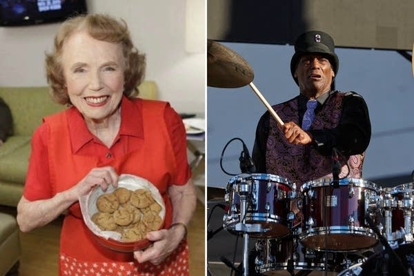 A woman holds up cookies. A man plays on the drums.