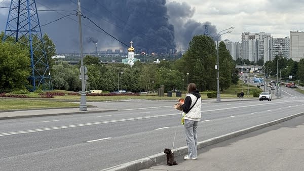 Above, black smoke rises from the Russian oil producer Gazprom Neft's Moscow oil refinery on June 18.