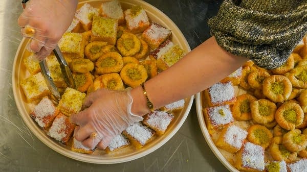 woman plates baklava for catering order
