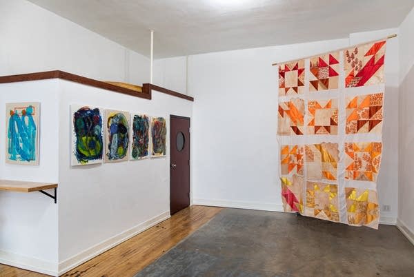 Art hangs against white walls