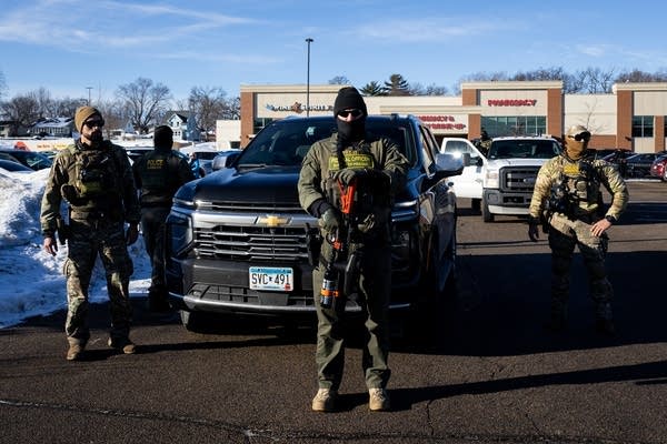 Federal agents in a parking lot