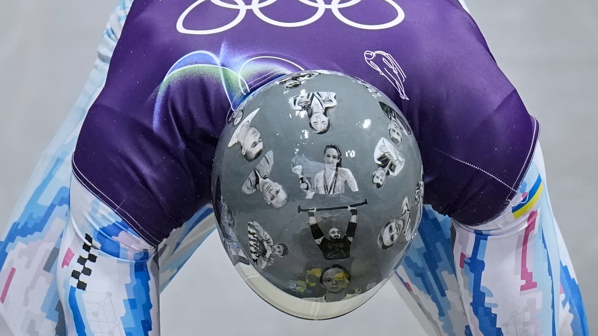 Ukrainian trains in helmet honoring fellow athletes killed in war. IOC says it's banned for race