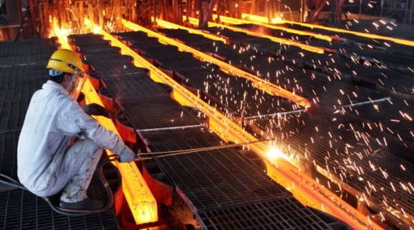  A worker cuts steel billets at an iron and steel enterprise in China.