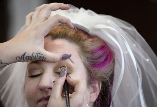 A closeup of makeup being applied to a woman's face