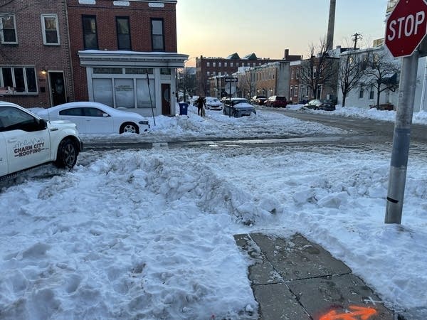 Snow covers a street corner in Baltimore, where schools have been closed all week.