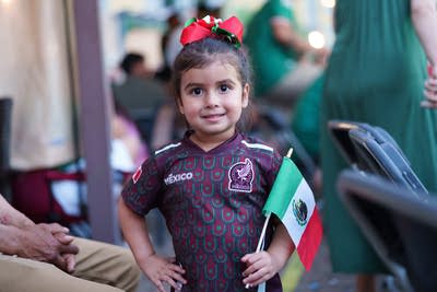 little girl poses with Mexico flag 