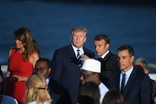BIARRITZ, FRANCE - AUGUST 25:  US President Donald Trump talks to France's President Emmanuel Macron as G7 leaders and guests gather for a family picture in front of the Biarritz lighthouse on the second day of the annual G7 summit on August 25, 2019 in Biarritz, France. 