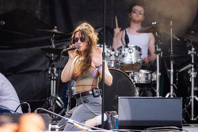Couch performing on an outdoor stage.