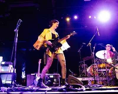 Two musicians performing together onstage