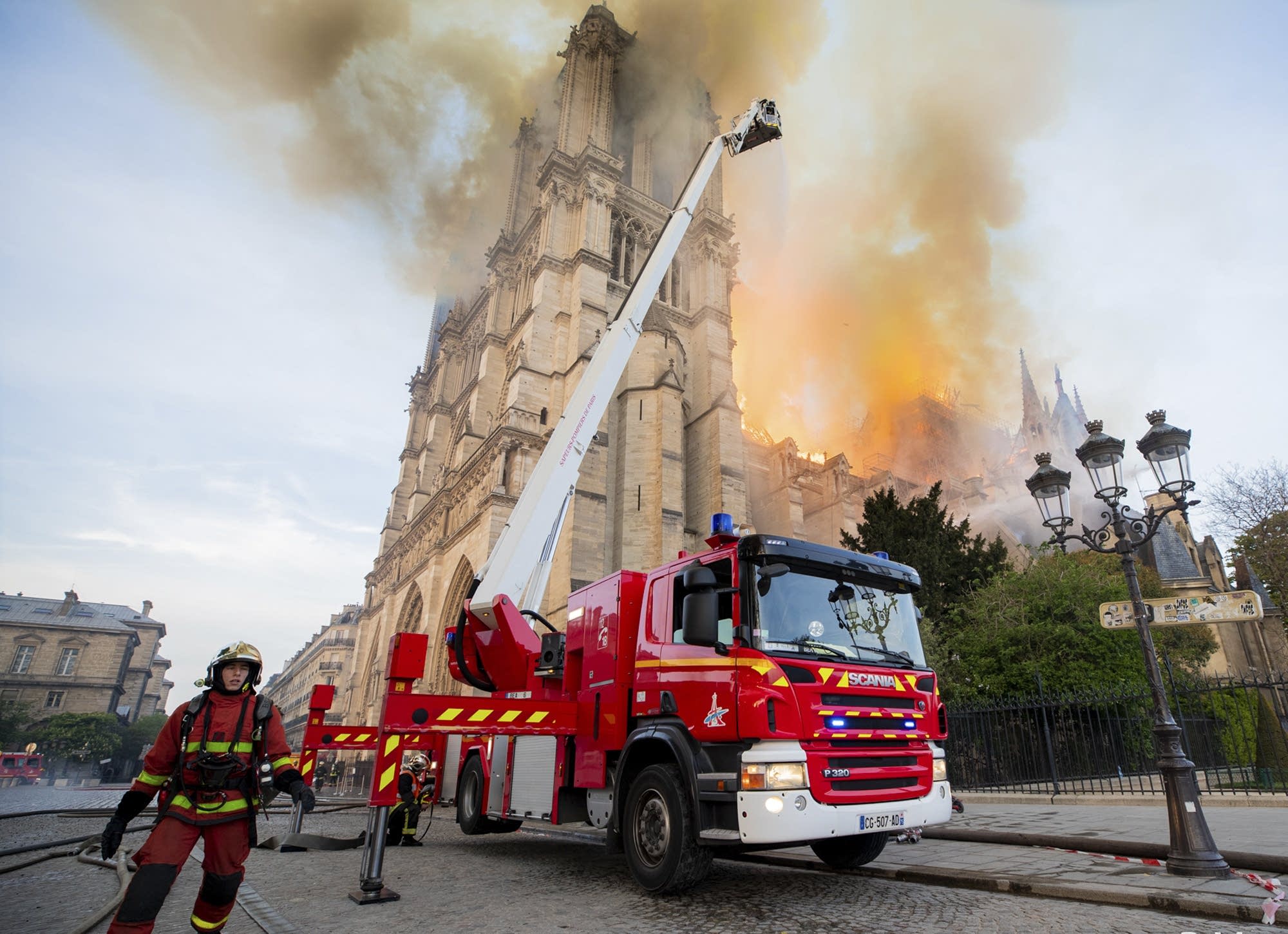 Firefighters work at the burning Notre Dame cathedral.