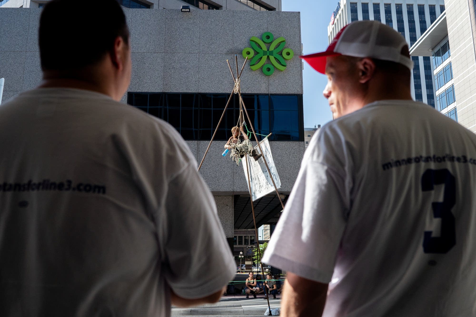 Supporters of the Enbridge line 3 oil pipeline watch an opponent.
