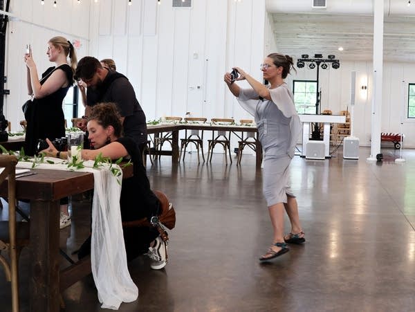 a woman holds her phone to take a photo