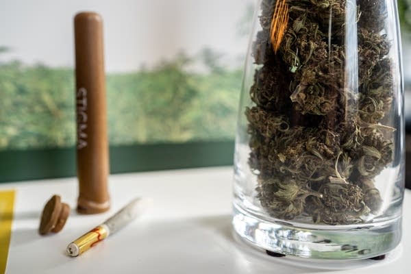 A jar of hemp sits next to a 1-gram