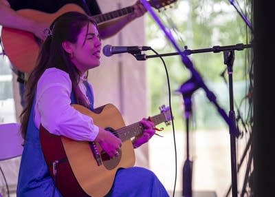 sara kae and her backing band performing on stage