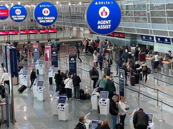 People stand in an airport.