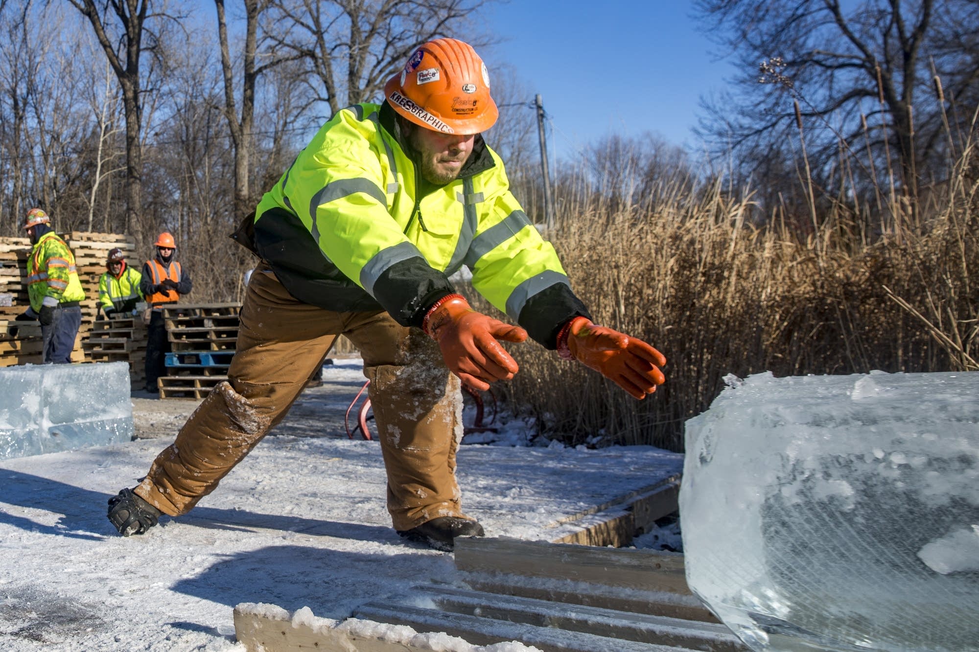A Park Construction worker receives a block of ice.
