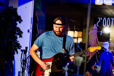 A musician plays guitar onstage