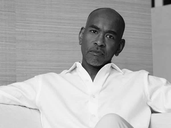 A black and white photo of a man sitting.