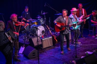 A large band performs on a stage.