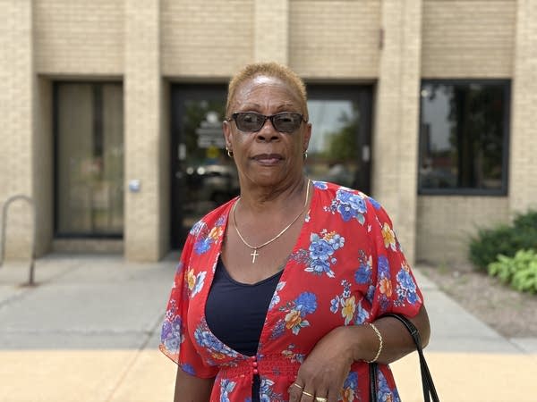 A woman in red and blue shirt with sunglasses