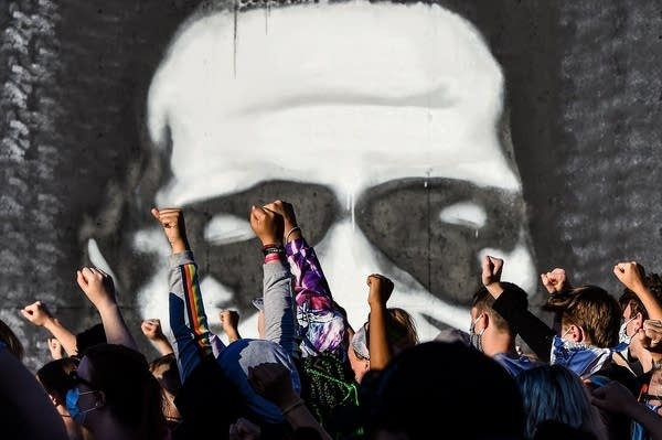 People raise their hands as they protest at the makeshift memorial in honour of George Floyd, on June 4, 2020 in Minneapolis. (CHANDAN KHANNA/AFP via Getty Images)