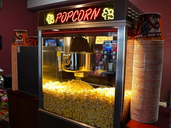 a popcorn machine at a movie theater concessions stand