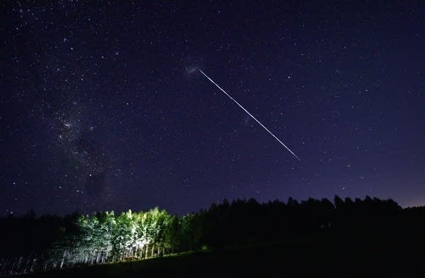 This long-exposure image shows a trail of a group of SpaceX's Starlink satellites passing over Uruguay as seen from the countryside some 185 km north of Montevideo near Capilla del Sauce, Florida Department, on February 6, 2021.