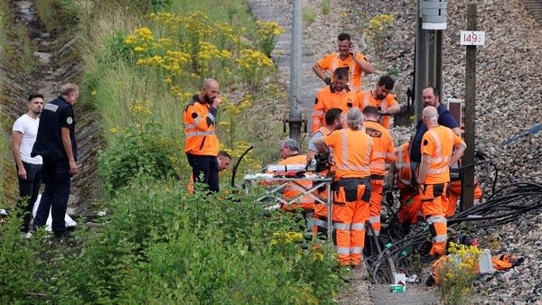 French railway employees inspect the scene of a suspected attack on the high speed railway network.